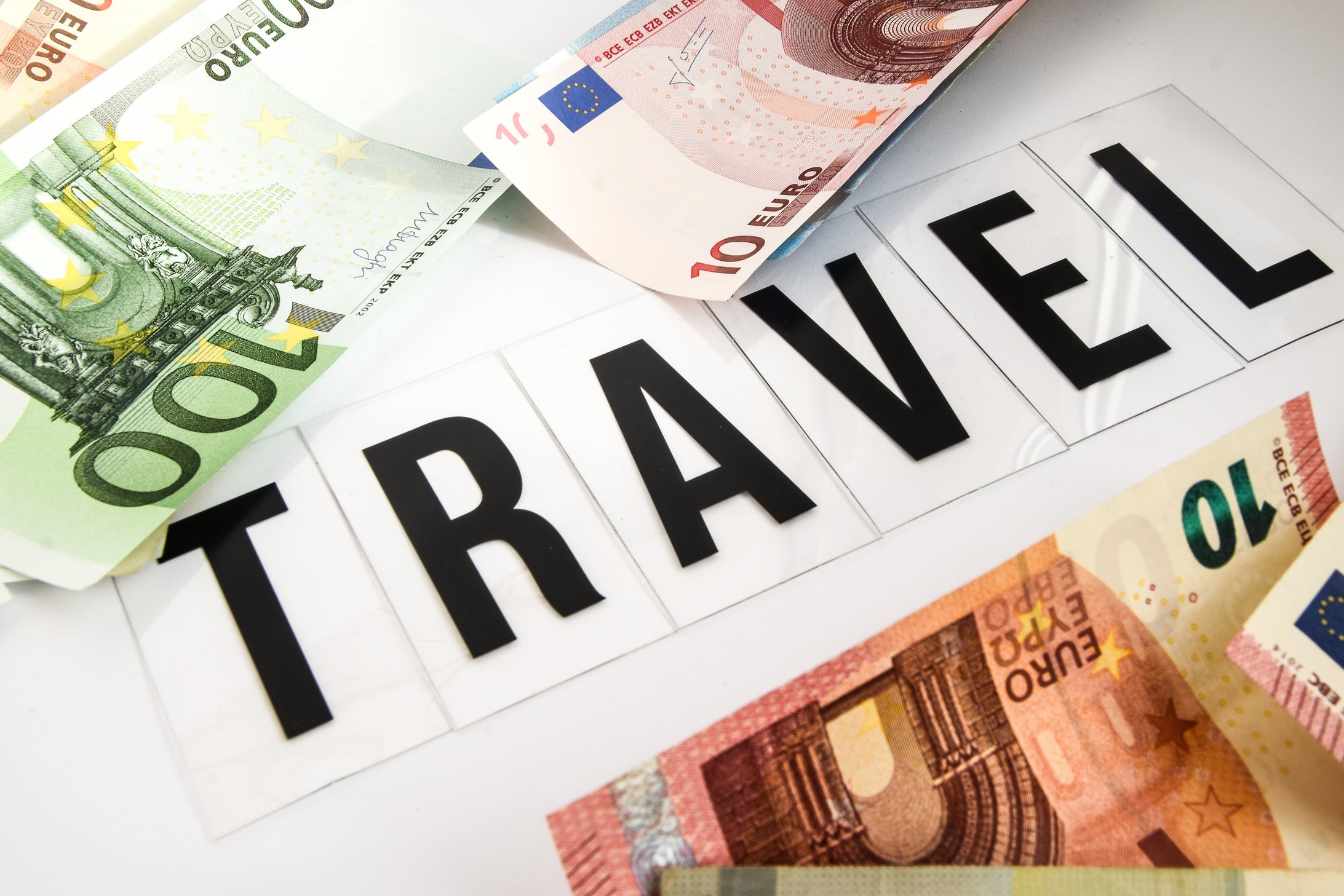 Euro Cash background. Euro Money Banknotes, inscription travel on white background, travel savings, travel expenses